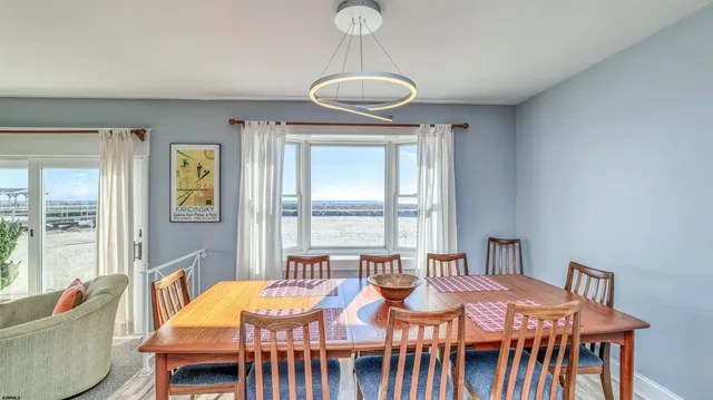 a view of a dining room with furniture wooden floor and chandelier
