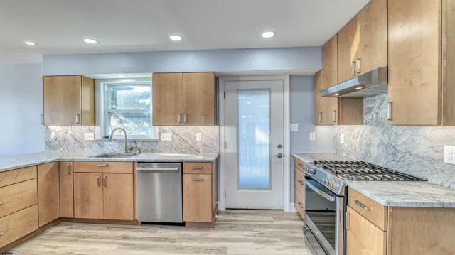 a kitchen with a refrigerator and a stove