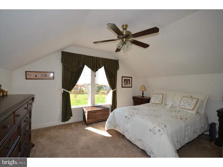 245 Barnhill Road Perkasie, PA 18944 - Photo 16 of 25 a bedroom with a bed and a chandelier