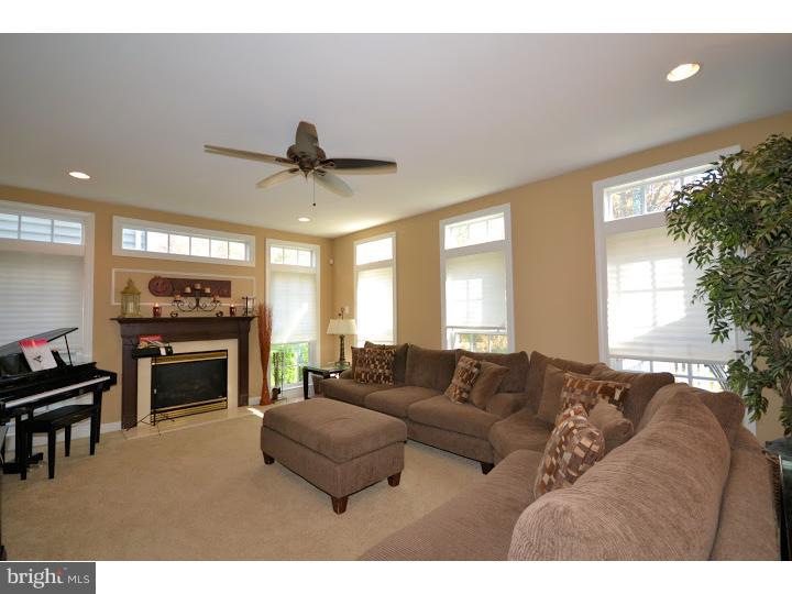 245 Barnhill Road Perkasie, PA 18944 - Photo 4 of 25 a living room with furniture a fireplace and a flat screen tv