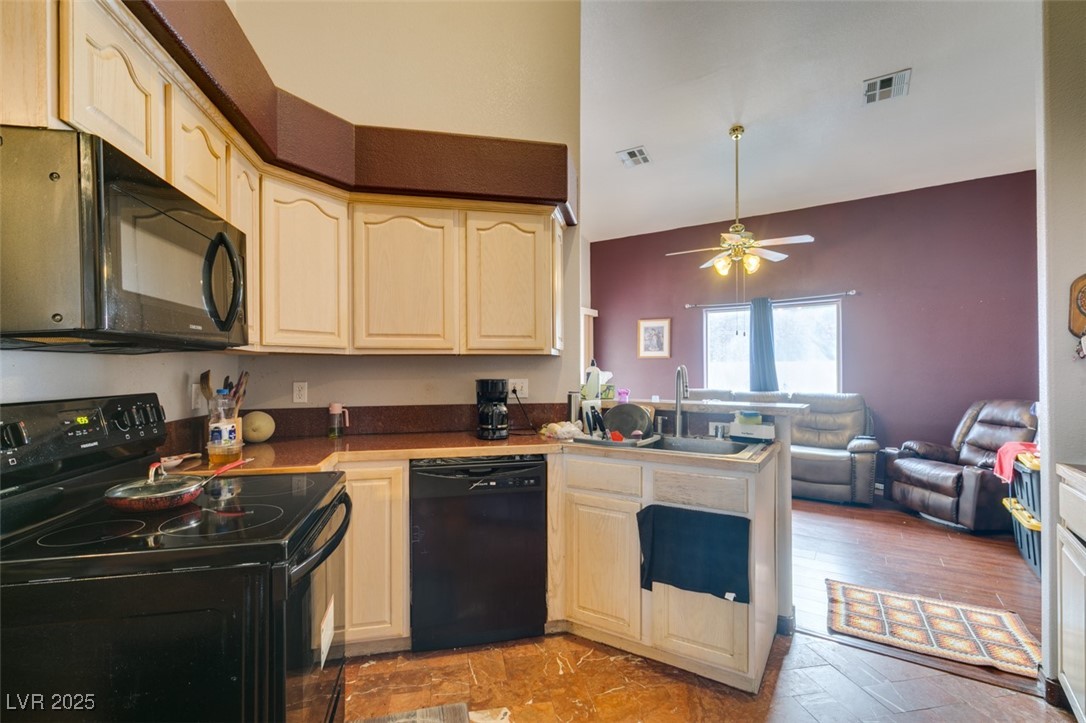 1860 Racine Drive Las Vegas, NV 89156 - Photo 36 of 36 Kitchen with black appliances, a peninsula, open floor plan, and a ceiling fan