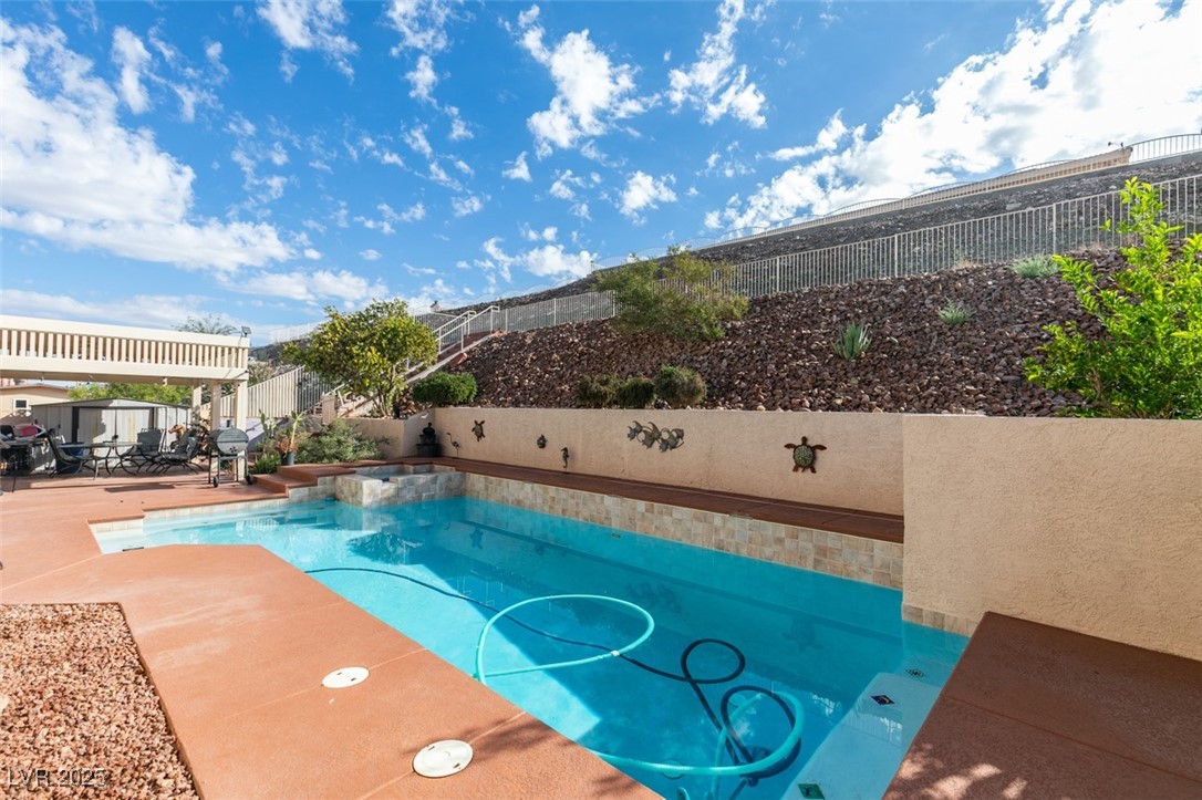 1860 Racine Drive Las Vegas, NV 89156 - Photo 2 of 36 View of pool featuring a fenced backyard, a patio, and a pool with connected hot tub