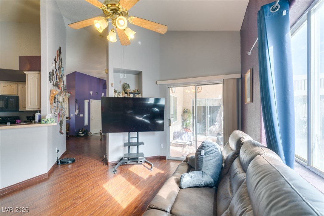 1860 Racine Drive Las Vegas, NV 89156 - Photo 21 of 36 Living room with healthy amount of natural light, high vaulted ceiling, wood finished floors, and a ceiling fan