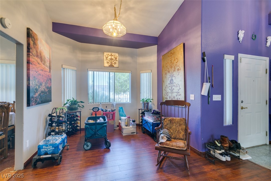 1860 Racine Drive Las Vegas, NV 89156 - Photo 30 of 36 Living area featuring dark wood-style floors and a chandelier