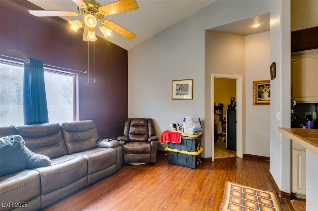 1860 Racine Drive Las Vegas, NV 89156 - Photo 32 of 36 Living area featuring a ceiling fan, wood finished floors, and vaulted ceiling