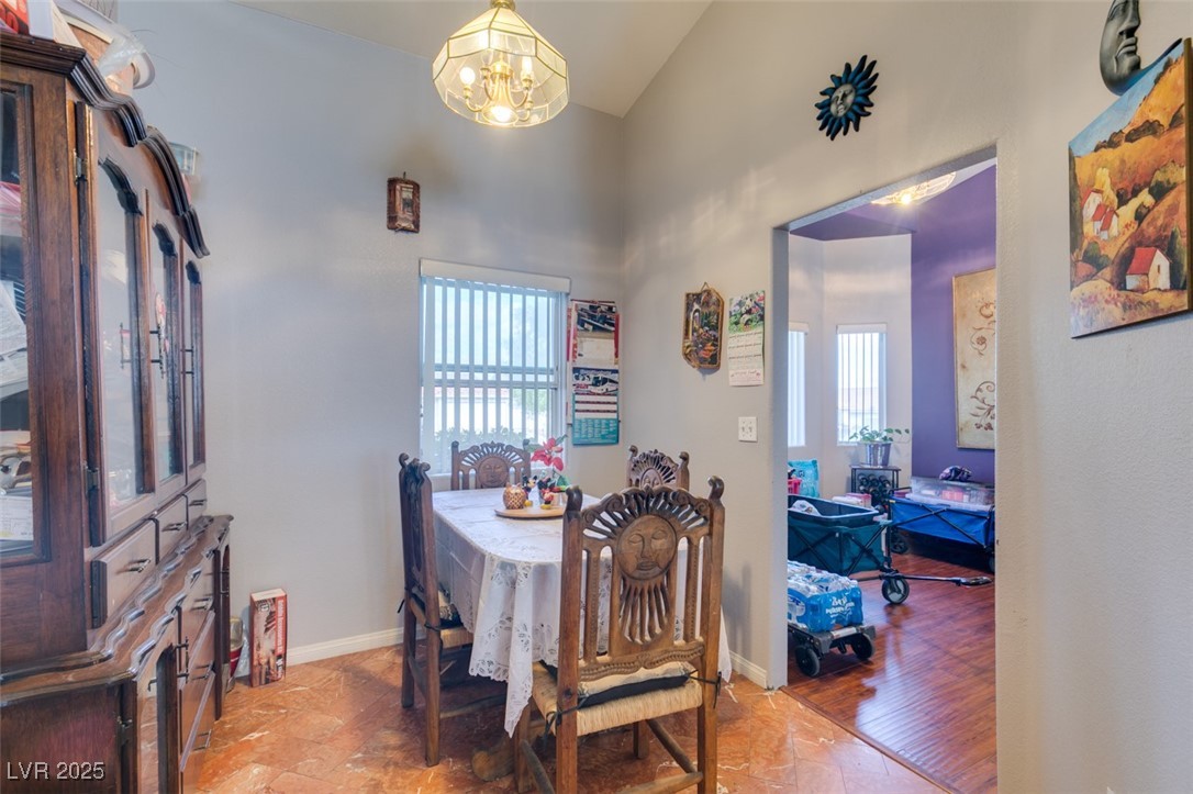 1860 Racine Drive Las Vegas, NV 89156 - Photo 7 of 36 Dining space featuring plenty of natural light, vaulted ceiling, and a chandelier