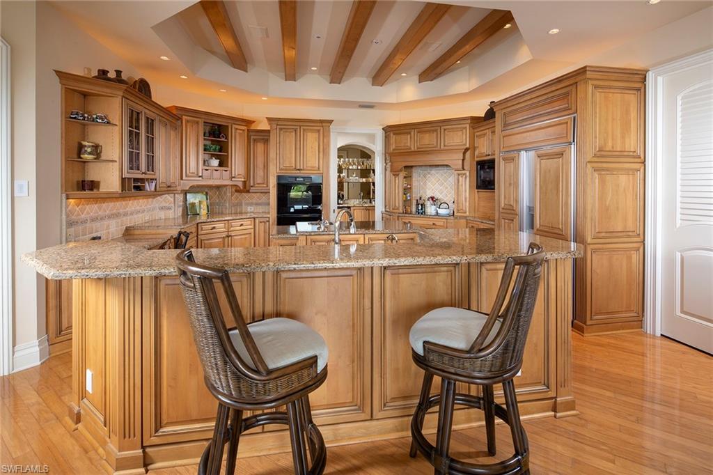 330 Neptunes Bight Naples, FL 34103 - Photo 2 of 8 a work room with furniture a sink a rug and a window
