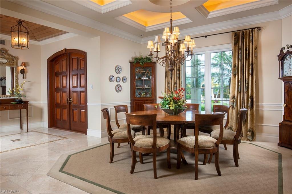330 Neptunes Bight Naples, FL 34103 - Photo 4 of 8 a view of a dining room with furniture window and chandelier