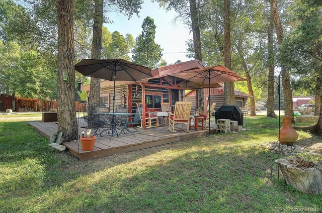 a view of a house with backyard porch and sitting area