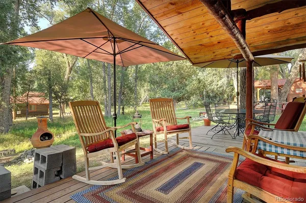 a patio with glass top table and chairs