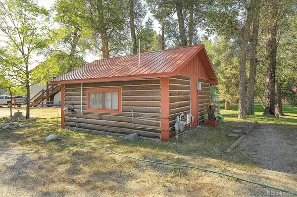a yellow house sitting in middle of forest