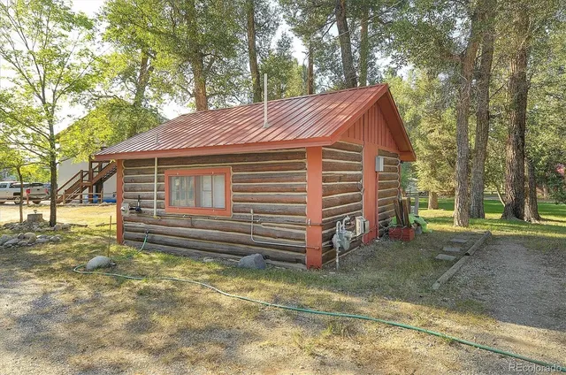 a yellow house sitting in middle of forest