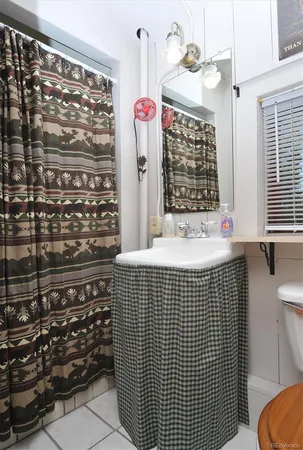 a bathroom with a sink a mirror and shower
