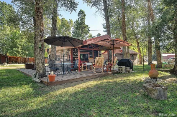 a view of a house with backyard fountain and sitting area