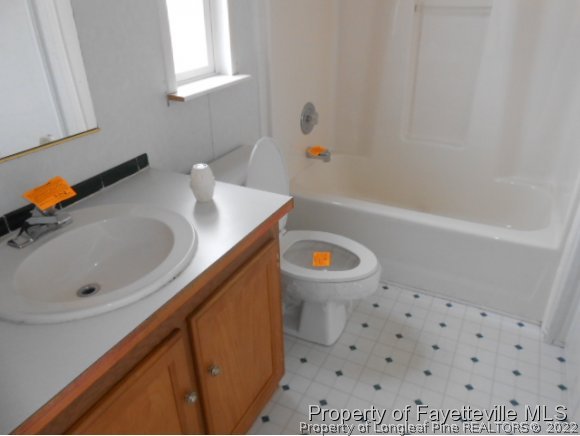 2454 Ebenezer Church Road Coats, NC 27521 - Photo 7 of 8 a bathroom with a sink a toilet and bathtub