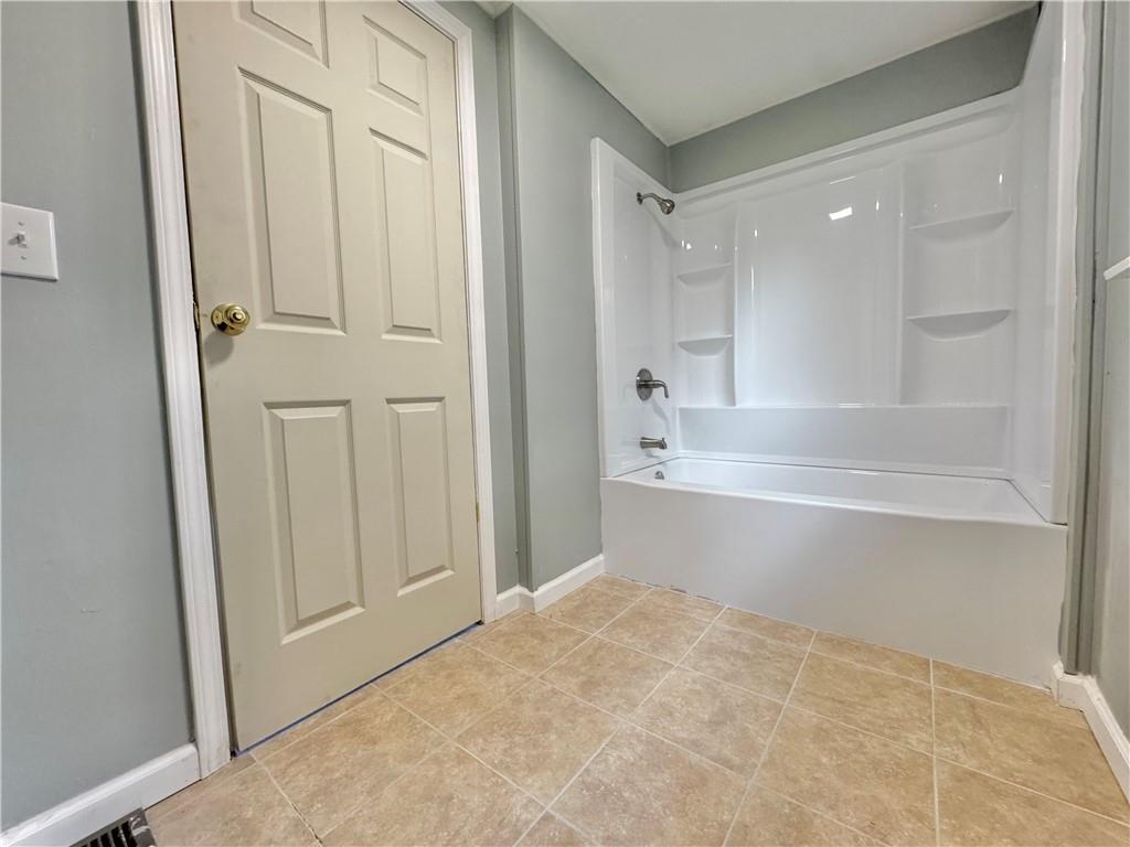 1285 Old Pulaski Road New Castle, PA 16105 - Photo 11 of 19 a bathroom with a bathtub and a shower
