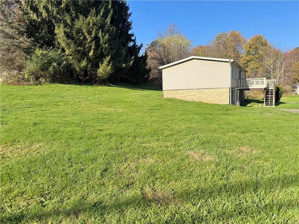 1285 Old Pulaski Road New Castle, PA 16105 - Photo 17 of 19 a backyard of a house with lots of green space and plants