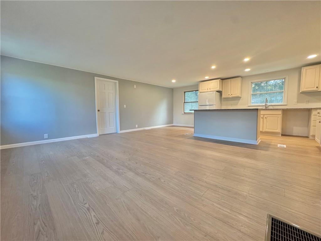 1285 Old Pulaski Road New Castle, PA 16105 - Photo 3 of 19 a view of kitchen and empty room with wooden floor