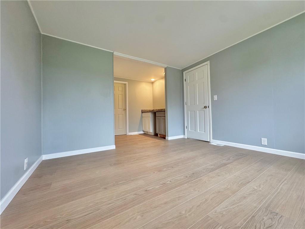 1285 Old Pulaski Road New Castle, PA 16105 - Photo 8 of 19 a view of an empty room with wooden floor and cabinets