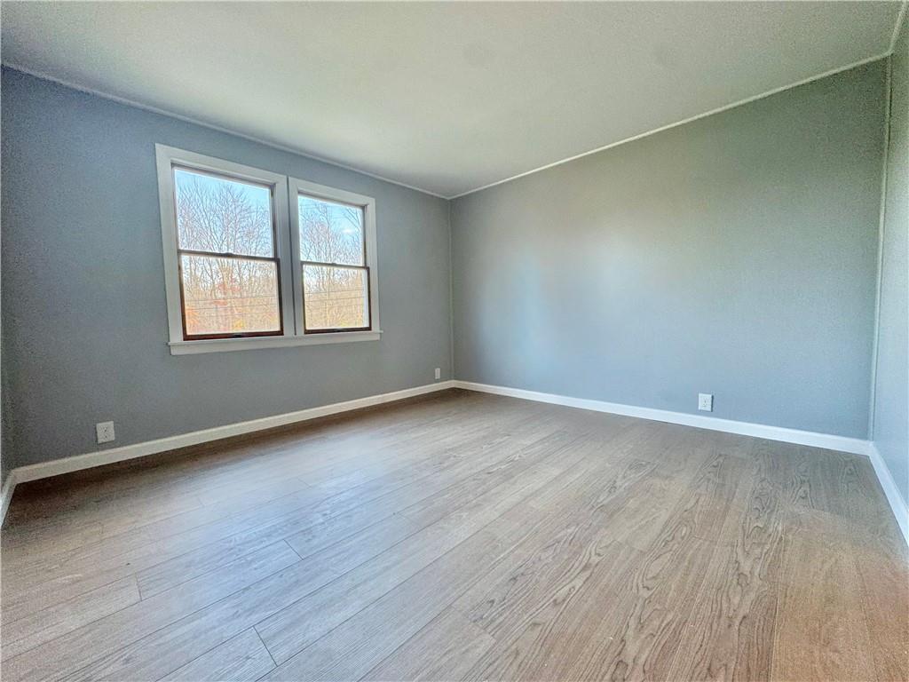 1285 Old Pulaski Road New Castle, PA 16105 - Photo 9 of 19 an empty room with wooden floor and windows