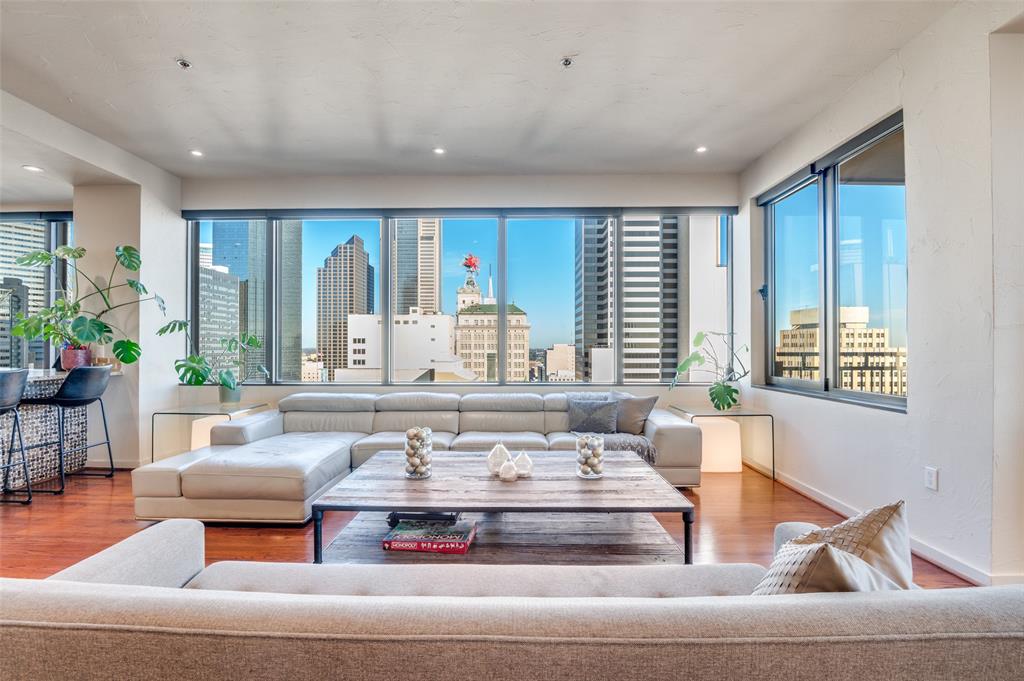 a living room with fireplace furniture and a large window