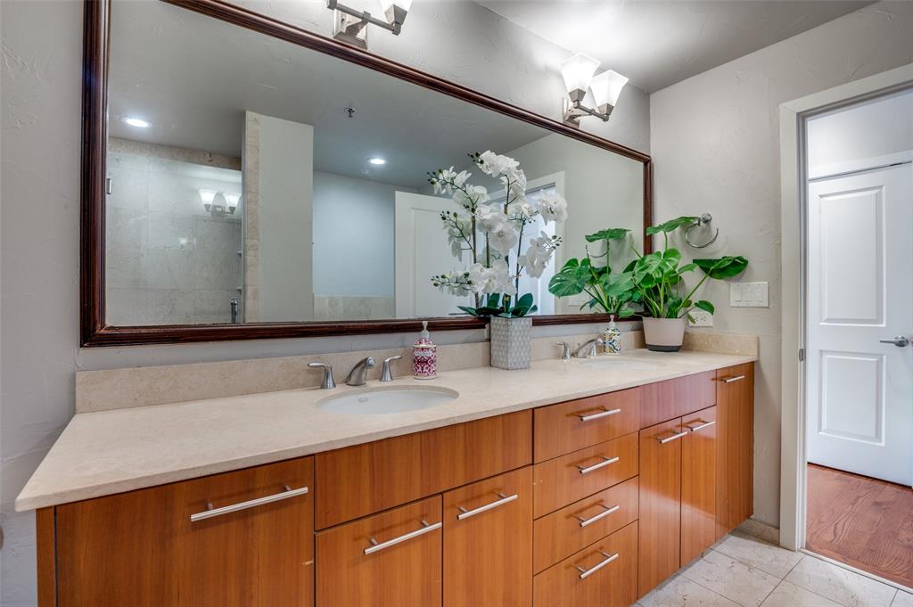 1200 Main Street, Unit 2412 Dallas, TX 75202 - Photo 17 of 36 a bathroom with a sink a vanity and a mirror