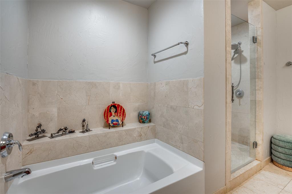 1200 Main Street, Unit 2412 Dallas, TX 75202 - Photo 18 of 36 a bathroom with a sink and a shower