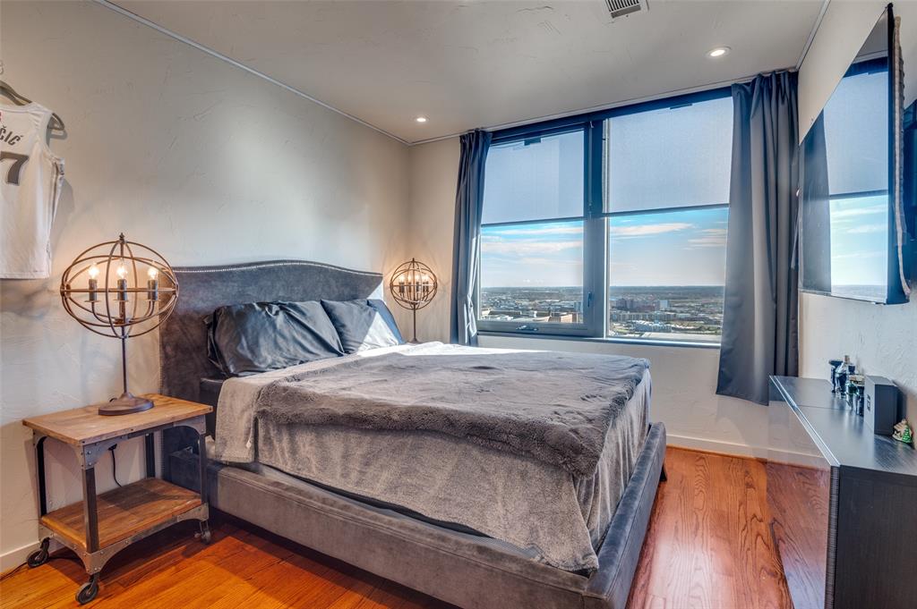 1200 Main Street, Unit 2412 Dallas, TX 75202 - Photo 21 of 36 a bedroom with a bed a window and walk in closet