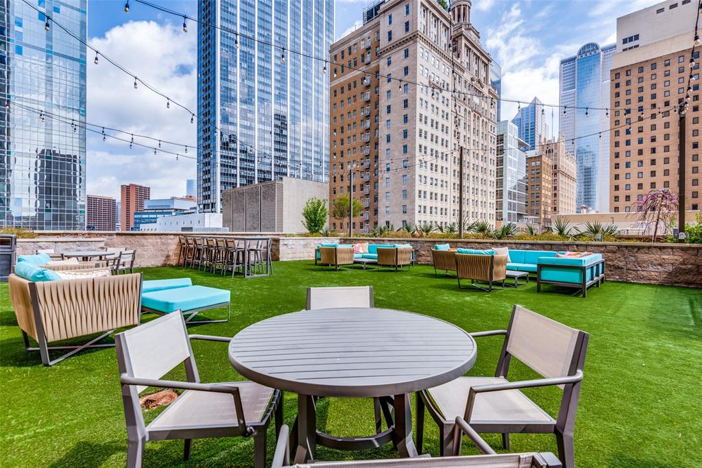 1200 Main Street, Unit 2412 Dallas, TX 75202 - Photo 35 of 36 a view of a table and chairs in the back yard