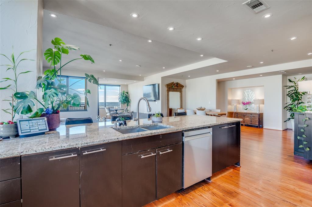 1200 Main Street, Unit 2412 Dallas, TX 75202 - Photo 10 of 36 a kitchen with sink and center island
