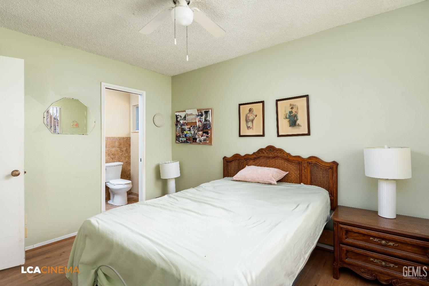 Undisclosed Address Bakersfield, CA 93306 - Photo 22 of 27 a bedroom with a bed and a lamp on table