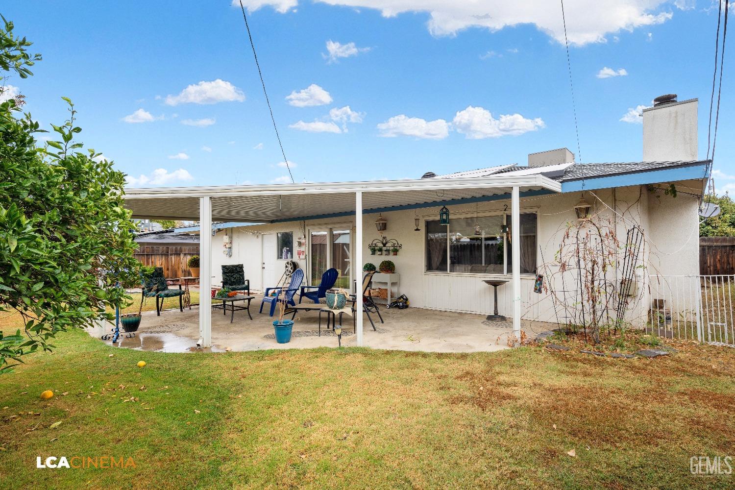 Undisclosed Address Bakersfield, CA 93306 - Photo 25 of 27 a front view of a house with a garden and patio