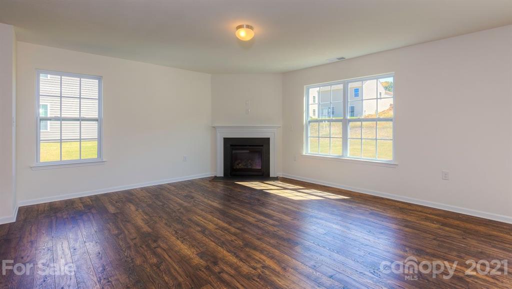 328 Gaines Road Clover, SC 29710 - Photo 11 of 34 an empty room with wooden floor and windows