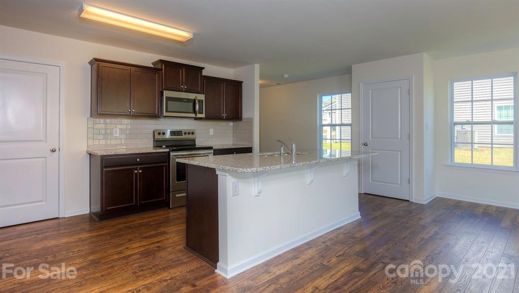 328 Gaines Road Clover, SC 29710 - Photo 3 of 34 a kitchen with granite countertop a stove top oven and sink