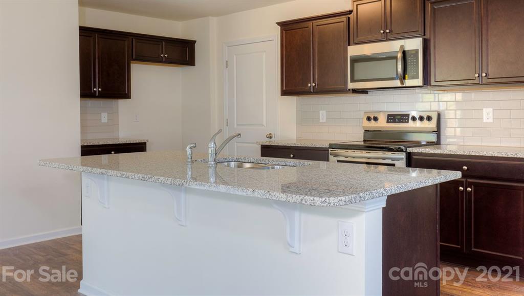 328 Gaines Road Clover, SC 29710 - Photo 5 of 34 a kitchen with stainless steel appliances granite countertop a sink stove and microwave