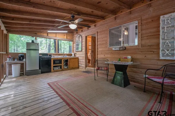 a view of a patio with table and chairs