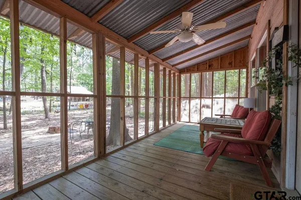 a view of a deck with wooden floor and outdoor seating