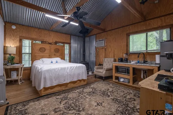 a bedroom with a bed and a large window