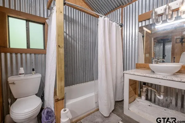 a bathroom with a toilet a sink and a bathtub