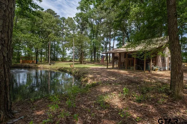 a view of a house with a yard and sitting area