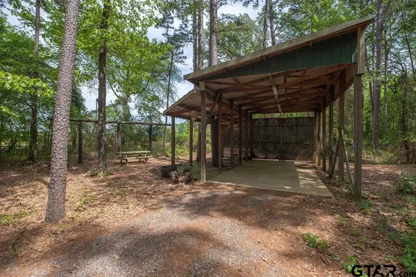a view of a barn with a large window and large tree