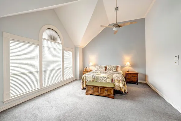 a bedroom with bed and window