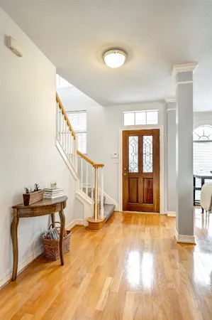 a view of an entryway with wooden floor and door