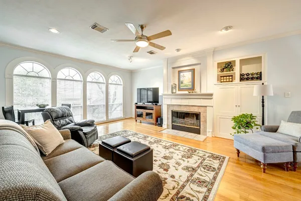 a living room with furniture large window and a fireplace