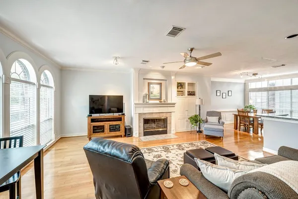 a living room with furniture fireplace and flat screen tv