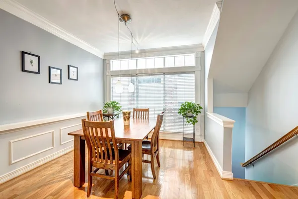 a view of a dining room with furniture window and wooden floor