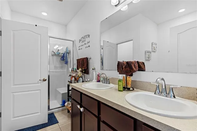 a bathroom with a double vanity sink and a mirror