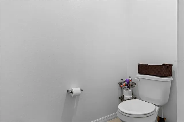 a white toilet sitting next to a bathroom sink