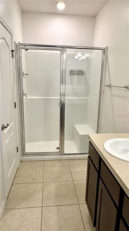 a bathroom with a shower and a sink