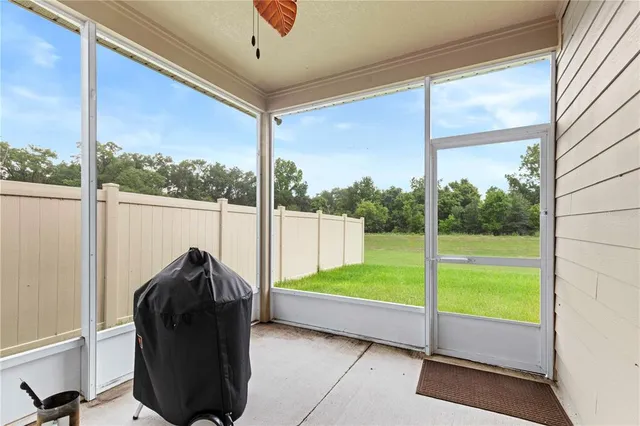 a view of a porch with furniture and garden